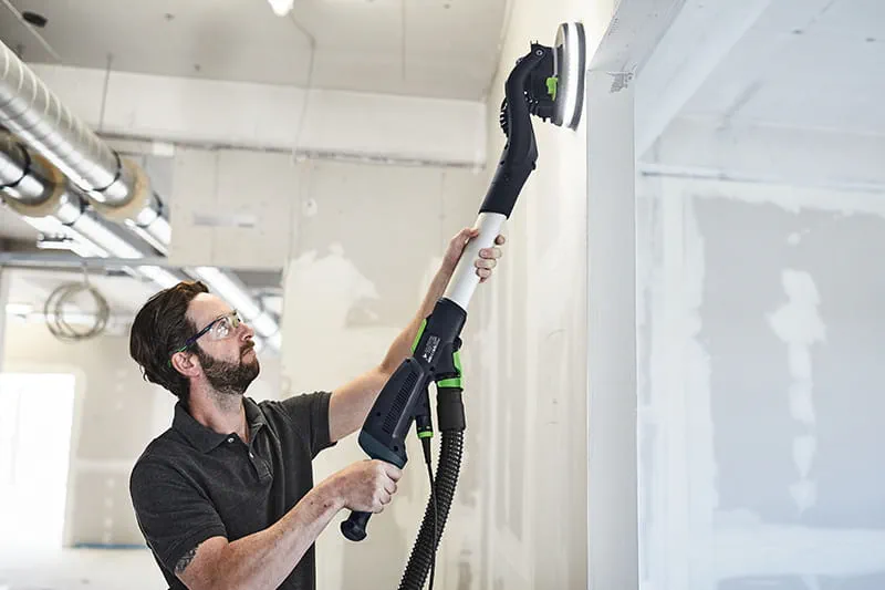 Tradesperson using a PLANEX Drywall Sander
